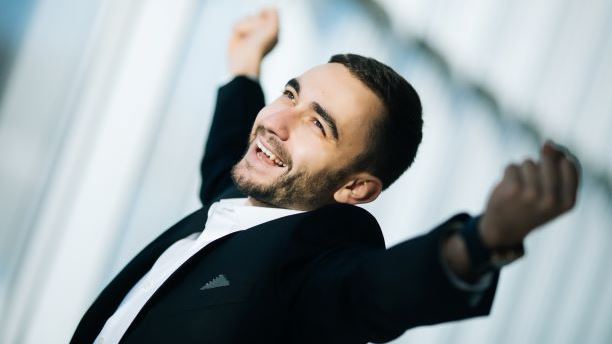 Entrepreneur holding hands up in success