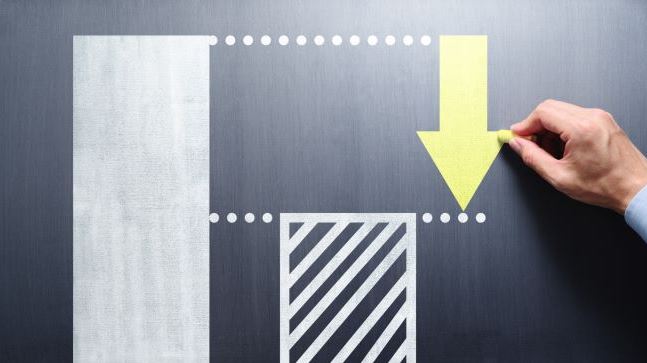 Arrow on chalk board pointing downwards