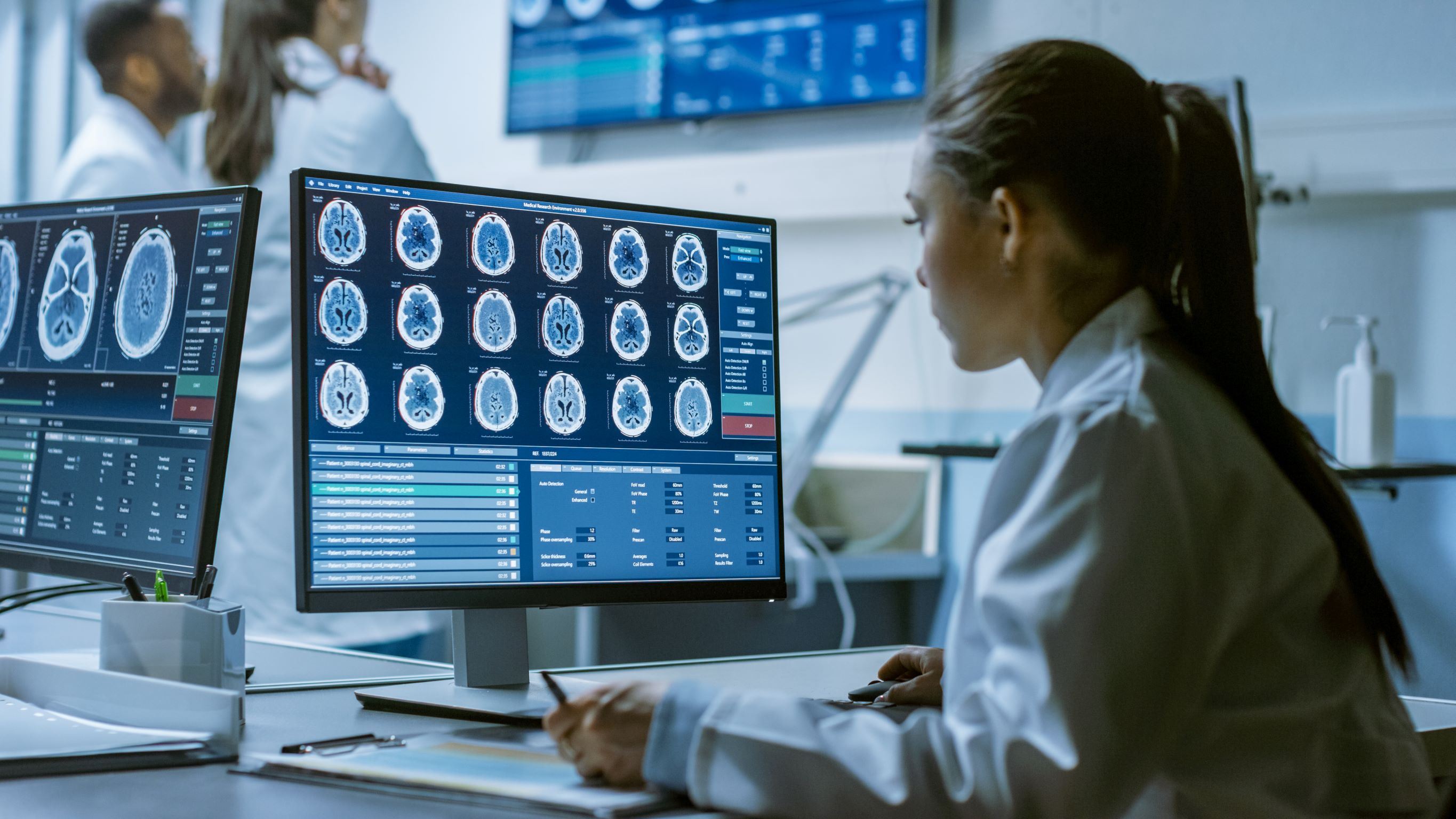 doctor looking at images of a brain on a desktop