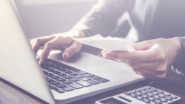 Person paying bills on laptop