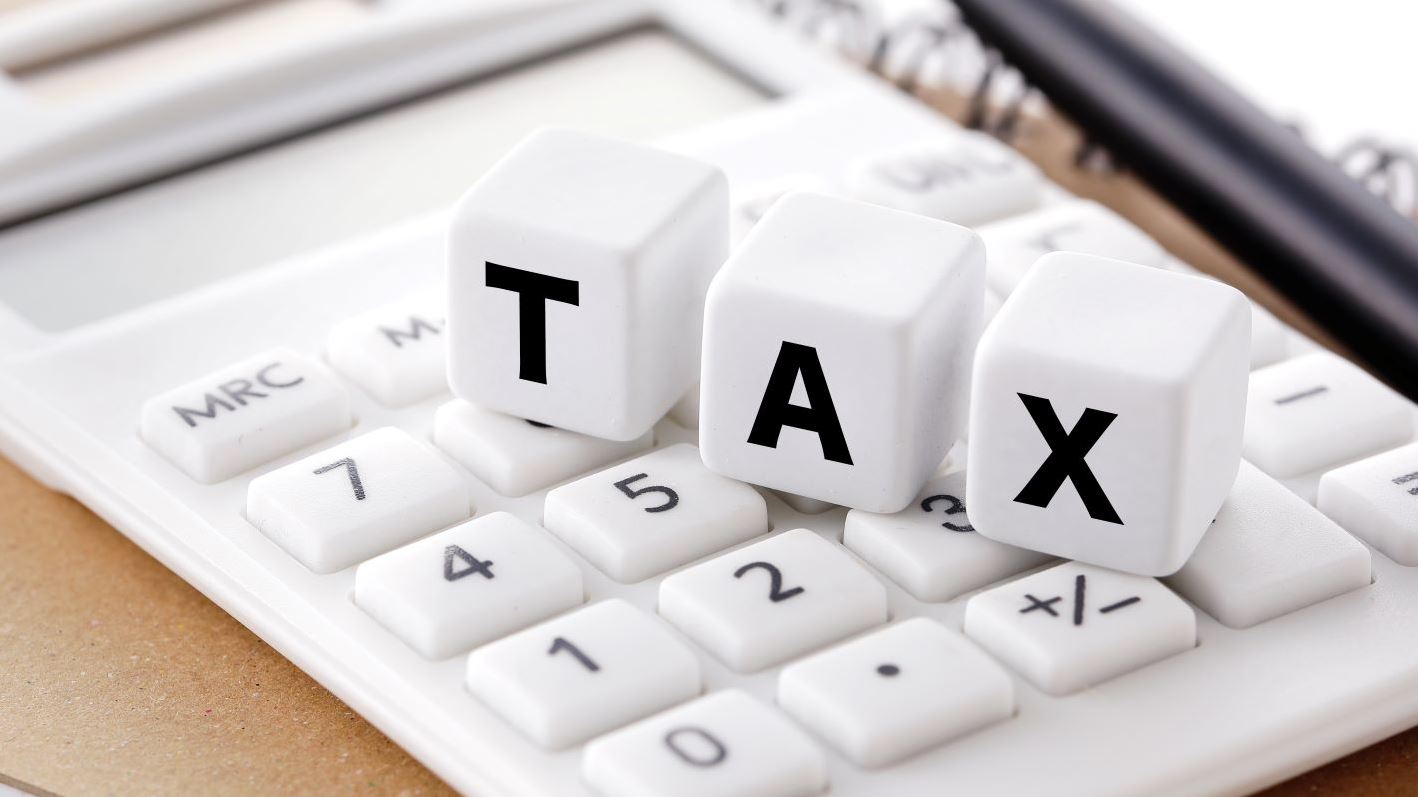 Image of a calculator and the word tax