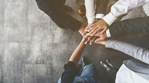 People putting their hand on top of each other