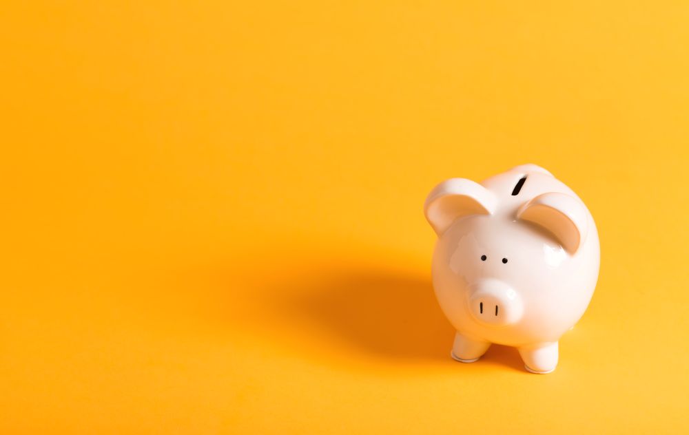 White Piggy Bank On Yellow Background