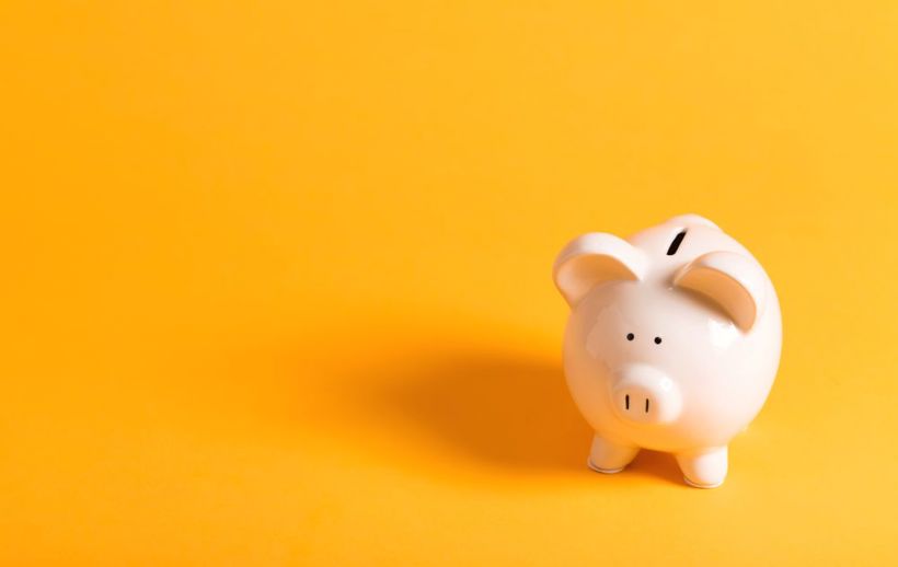White Piggy Bank On Yellow Background