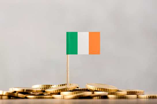 Irish Flag Stuck In Pile Of Coins